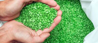 Hands holding biodegradable plastic pellets